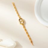 Helena® - Reloj dorado con esfera ovalada y bisel negro