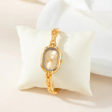 Helena® - Reloj dorado con esfera ovalada y bisel negro