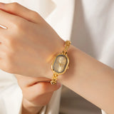 Helena® - Reloj dorado con esfera ovalada y bisel negro